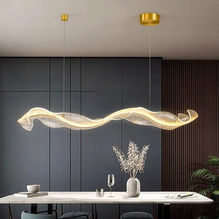 Paige Linear Dining Room Chandelier in gold over rectangular table